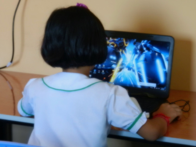 Primary school girl using donated computer
