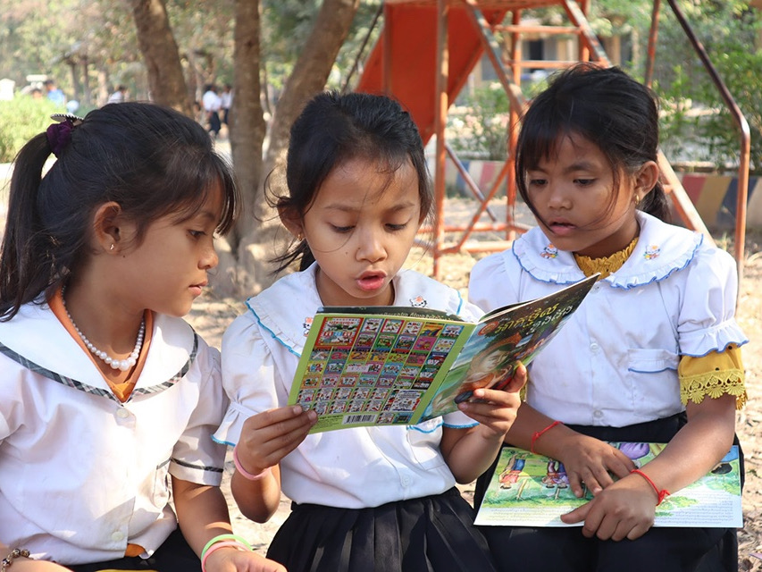 Girls reading donated school book